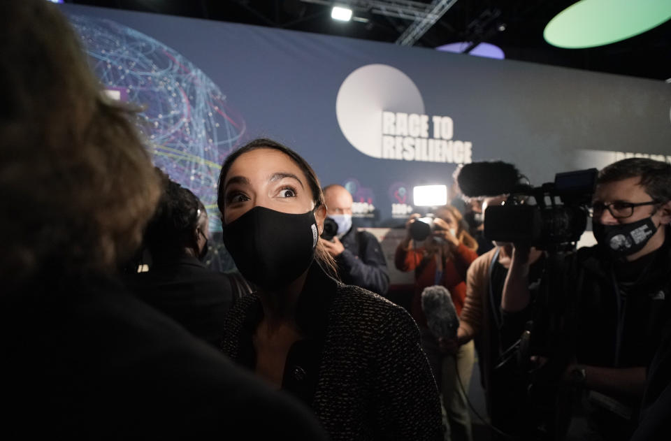 U.S. Rep. Alexandria Ocasio-Cortez, center, arrives at the venue of the COP26 U.N. Climate Summit in Glasgow, Scotland, Tuesday, Nov. 9, 2021. The U.N. climate summit in Glasgow has entered it's second week as leaders from around the world, are gathering in Scotland's biggest city, to lay out their vision for addressing the common challenge of global warming. (AP Photo/Alberto Pezzali)