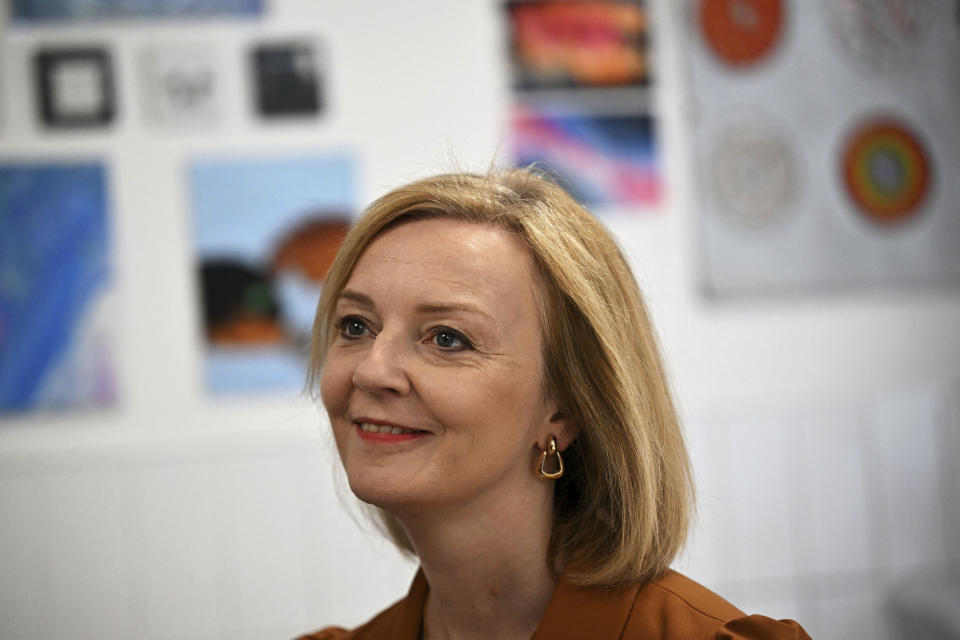 Conservative Party leadership candidate Liz Truss smiles during a visit to the Onside Future Youth Zone in London, Monday, Aug. 8, 2022. As Britain swelters through a roasting summer, and braces for a cold financial reckoning in the fall, calls for the Conservative government to act are getting louder.But the Conservatives are busy choosing a new leader, through a prolonged party election whose priorities often seem remote from the country’s growing turmoil. (Dylan Martinez/PA via AP)