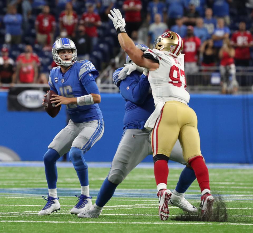 Detroit Lions quarterback Jared Goff is pressured by San Francisco 49ers defensive end Nick Bosa as left tackle Penei Sewell blocks Sunday, Sept. 12, 2021 at Ford Field.