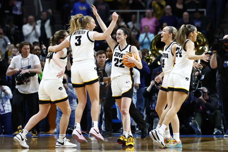 Iowa Hawkeyes guard Caitlin Clark celebrates with teammates after defeating LSU on April 1. (Winslow Townson-USA TODAY Sports)