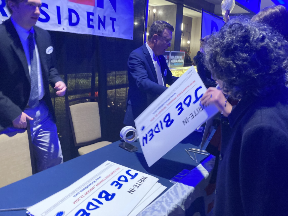 Volunteers distribute yard signs promoting the "Write In Biden" effort at a New Hampshire Democratic Party fundraiser, Dec. 1, 2023.