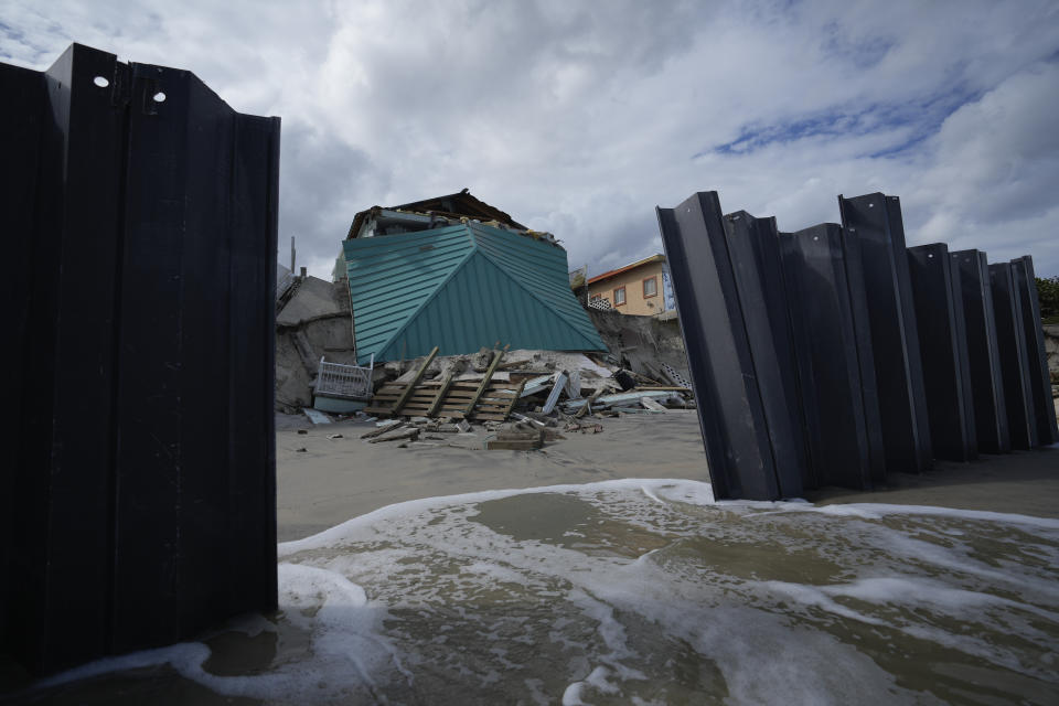FILE - A home lies collapsed after the beach on which it stood was eroded, following the passage of Hurricane Nicole, Nov. 11, 2022, in Wilbur-By-The-Sea, Fla. National Oceanic and Atmospheric Administration on Thursday, May 25, 2023, announced its forecast for the 2023 hurricane season. (AP Photo/Rebecca Blackwell, File)