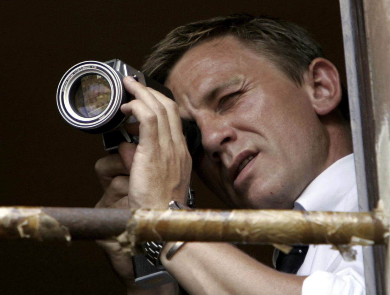 Actor Daniel Craig looks over a scene during the filming of a James Bond movie at the Palio horse race in Siena's main square August 16, 2007. Every July 2 and August 16, almost without fail since the mid-1600s, 10 riders have hurtled bareback around Siena's shell-shaped central square in a desperate bid to win the Palio, a silk banner depicting the Madonna and child. REUTERS/Marco Bucco    (ITALY)