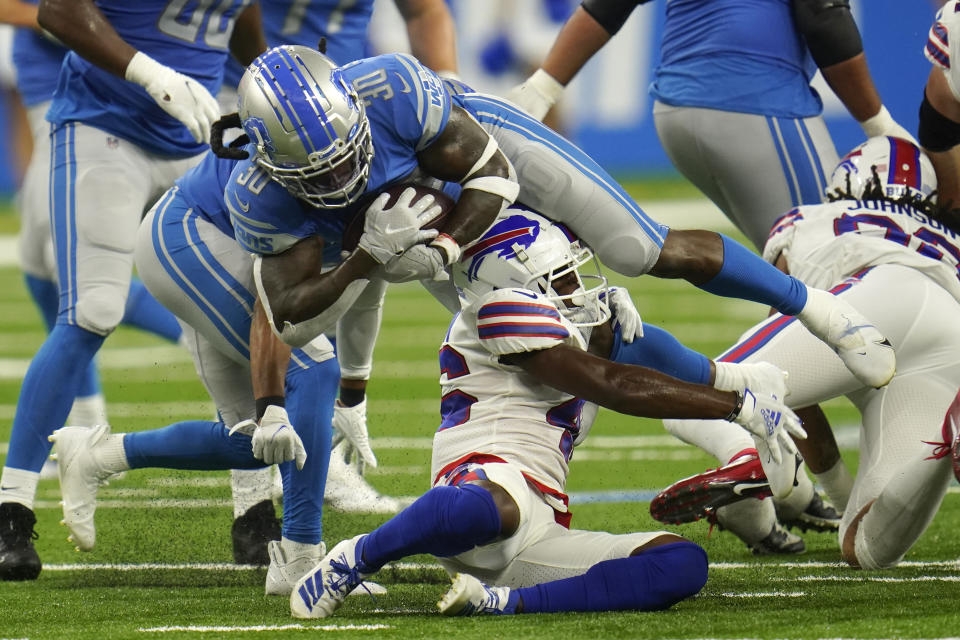 Detroit Lions running back Jamaal Williams (30) is tackled by Buffalo Bills defensive back Jaquan Johnson (46) during the first half of a preseason NFL football game, Friday, Aug. 13, 2021, in Detroit. (AP Photo/Paul Sancya)