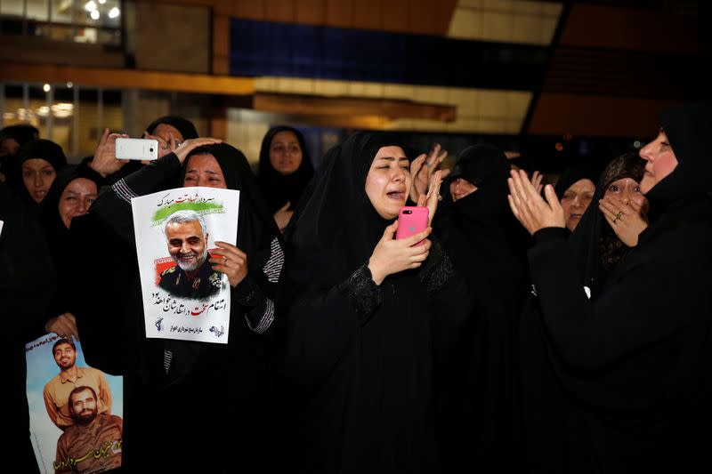 Iranian mourners react upon the arrival of bodies of the Iranian Major-General Qassem Soleimani, head of the elite Quds Force, and the Iraqi militia commander Abu Mahdi al-Muhandis, who were killed in an air strike at Baghdad airport, at Ahvaz internationa