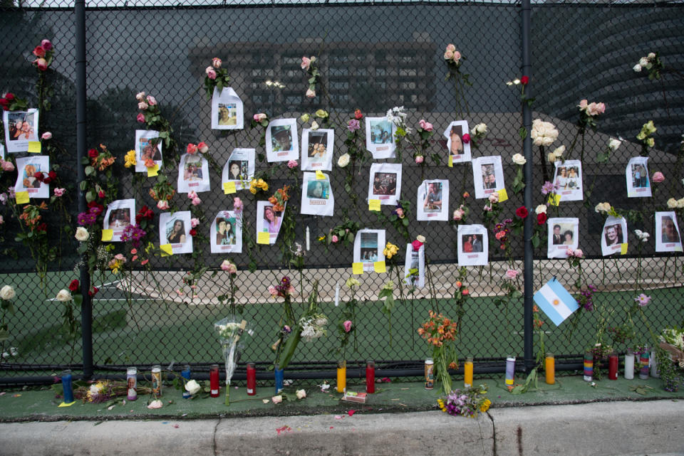 A makeshift memorial showing photos of people missing following the apartment building's collapse in Florida.