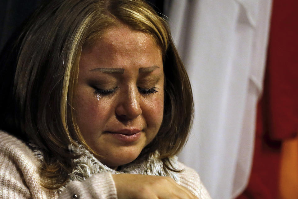 In this Friday, Feb. 8, 2019 photo, a Syrian woman who identified herself as Mae weeps as she speaks about her brother who was kidnapped in 2013 and has been missing since then before a team of Syrian actors and actresses reacted her story on stage in a playback theater in Beirut, Lebanon. Syrians from different parts of their war-torn country have gathered inside a theater telling their stories that are later re-acted by a group of Syrians who have been training on playback theater. (AP Photo/Bilal Hussein)