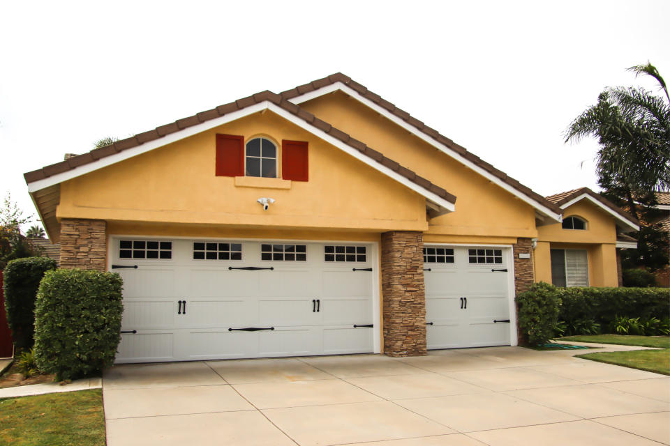 home with a wide driveway and three car garage