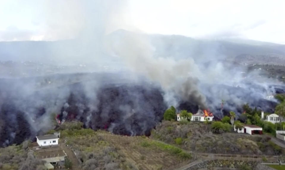 In this image made from video provided by OVERON, lava is seen after a volcanic eruption in La Palma, Spain, Monday, Sept. 20, 2021. Giant rivers of lava are tumbling slowly but relentlessly toward the sea after a volcano erupted on a Spanish island off northwest Africa. The lava is destroying everything in its path Monday, but prompt evacuations helped avoid casualties after Sunday's eruption. (OVERON via AP)