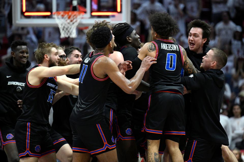 Boise State Broncos players celebrate on the court after defeating the San Diego State Aztecs at Viejas Arena.