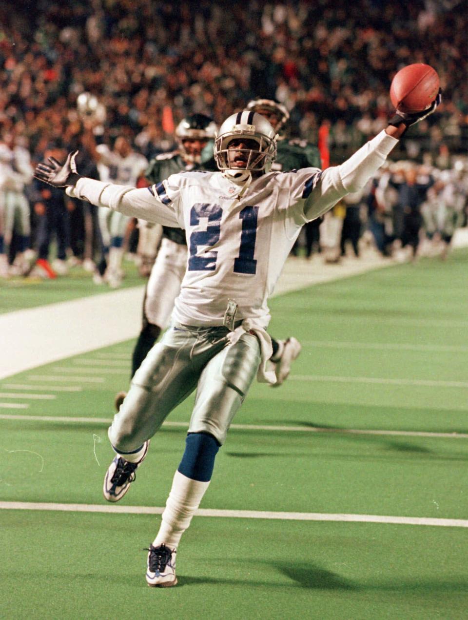 Dallas Cowboys' Deion Sanders celebrates after returning a punt for a touchdown against the Philadelphia Eagles in 1998.