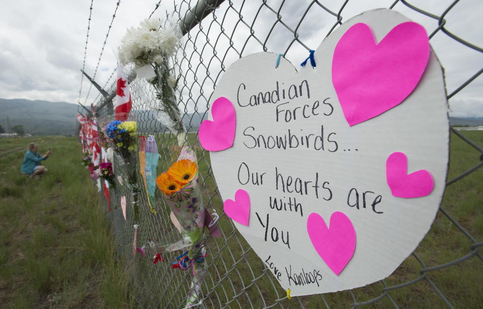 Signs are attached to the fence of the Kamloops airport to show respect for the Canadian Forces Snowbirds in Kamloops, British Columbia, Monday, May 18, 2020. Capt. Jenn Casey died Sunday after the Snowbirds jet she was in crashed shortly after takeoff. The pilot of the aircraft is in hospital with serious injuries. (Jonathan Hayward/The Canadian Press via AP)