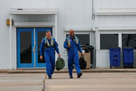 NASA commercial crew astronauts Victor Glover and Michael Hopkins walk out to their aircraft prior to a training flight in Houston, Texas