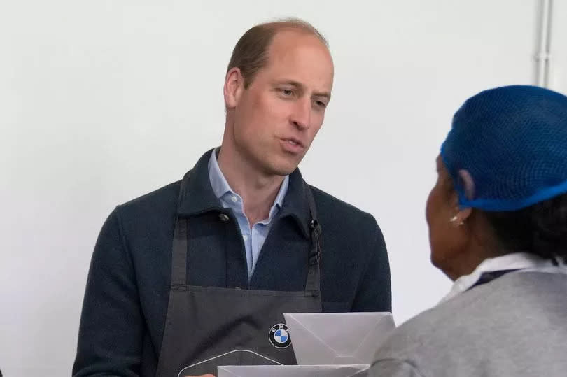 William is given get well cards for Kate and the King by a volunteer