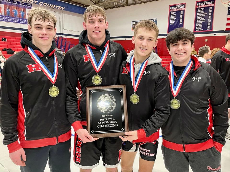 Hornet captains celebrate the 2023-24 District 2 Team Duals title after defeating Berwick in the Class AA finals. Pictured are (from left): Joey Giannetti, Joel Landry, Mason Avery, Julian Pons.