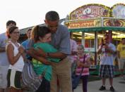 President Barack Obama hugs high school student and supporter Joy Dannelly, during a visit to the Iowa State Fair, August 13, 2012.