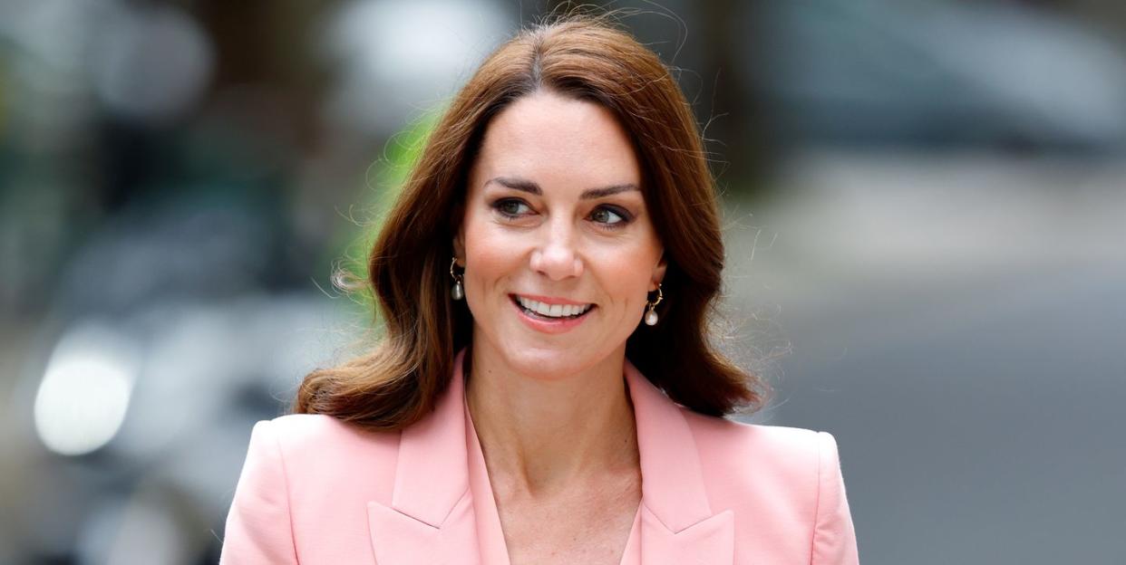 the princess of wales wearing a pink suit jacket and top