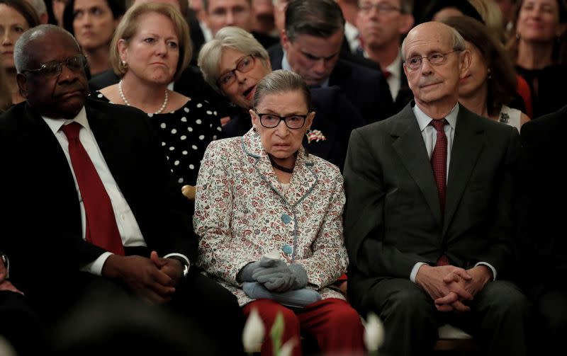 FILE PHOTO: U.S. Supreme Court Associate Justices Thomas, Ginsburg and Breyer watch as Brett Kavanaugh takes ceremonial oath in the East Room of the White House in Washington