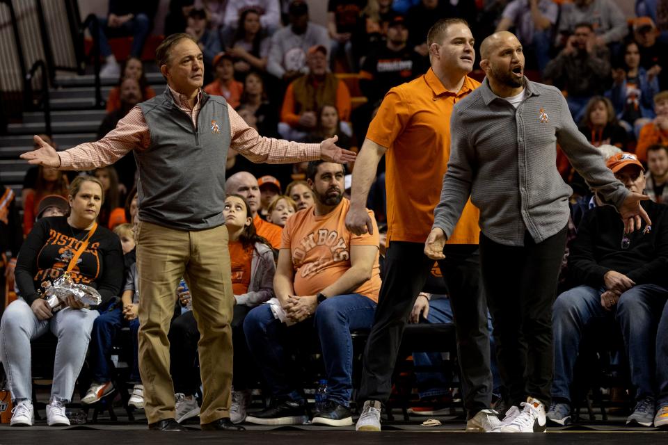  Oklahoma State CoachÕs (L-R) John Smith, Chris Perry and Zack Esposito react from the sideline during a NCAA wrestling match between Oklahoma State University (OSU) and Lehigh University at Gallagher-Iba Arena in Stillwater, Sunday, January 23, 2022. 