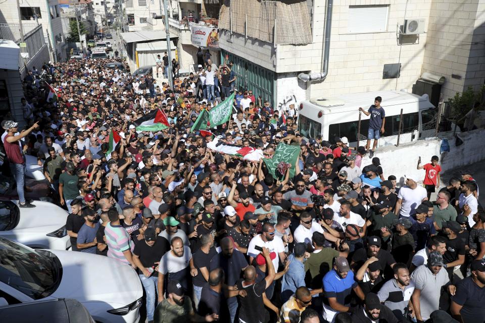 Mourners carry the body of Mohammed Obeid, a 20 year-old Palestinian killed in a clash with Israeli police on June 27, during his funeral in east Jerusalem, Monday, July 1, 2019. (AP Photo/Mahmoud Ilean)