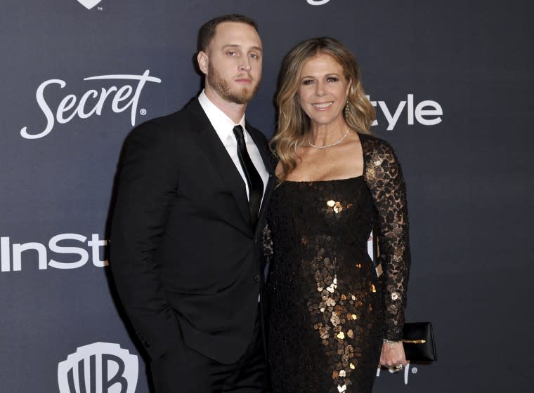 Chet Hanks posing for a red-carpet photo alongside Rita Wilson