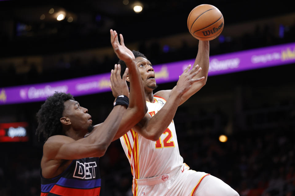 Atlanta Hawks forward De'Andre Hunter, right, shoots against Detroit Pistons center James Wiseman during the first half of an NBA basketball game Tuesday, March 21, 2023, in Atlanta. (AP Photo/Alex Slitz)