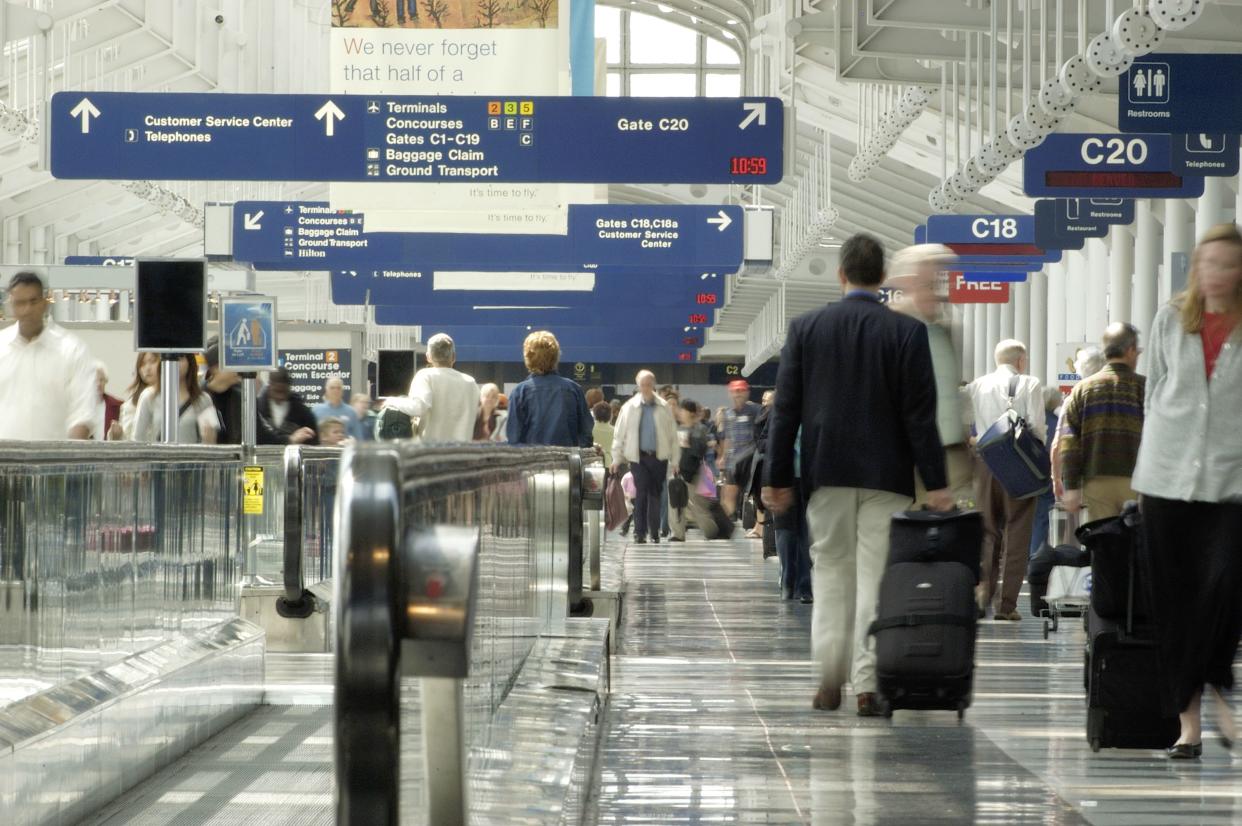 Travelers rushing through one of Chicago O'Hare airport terminals.