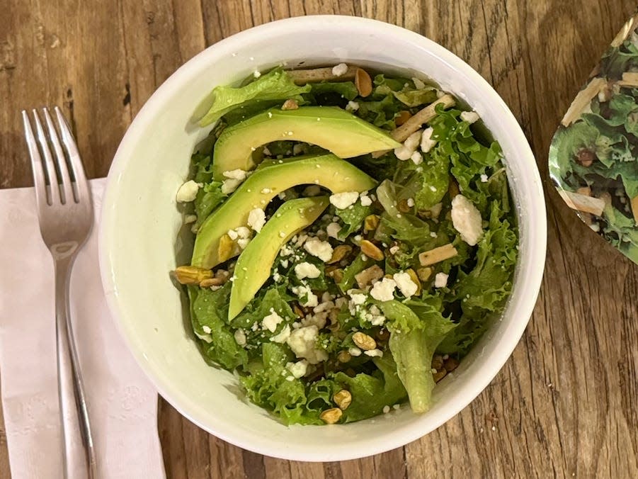 prepared salad next to a boxed salad kit from the store