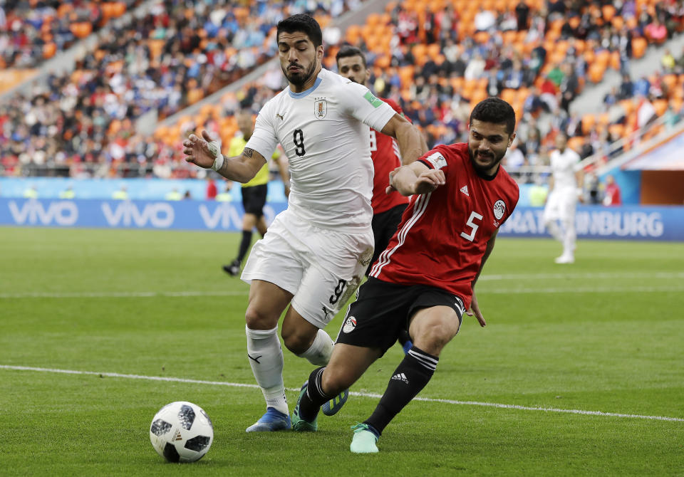 Uruguay’s Luis Suarez, left, challenges for the ball with Egypt’s Sam Morsy during the group A match between Egypt and Uruguay at the 2018 soccer World Cup in the Yekaterinburg Arena in Yekaterinburg, Russia, Friday, June 15, 2018. (AP Photo/Natacha Pisarenko)