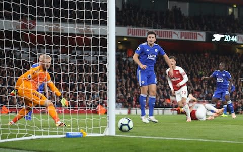 Kasper Schmeichel and Harry Maguire can only watch as Mesut Ozil equalises - Credit: getty Images