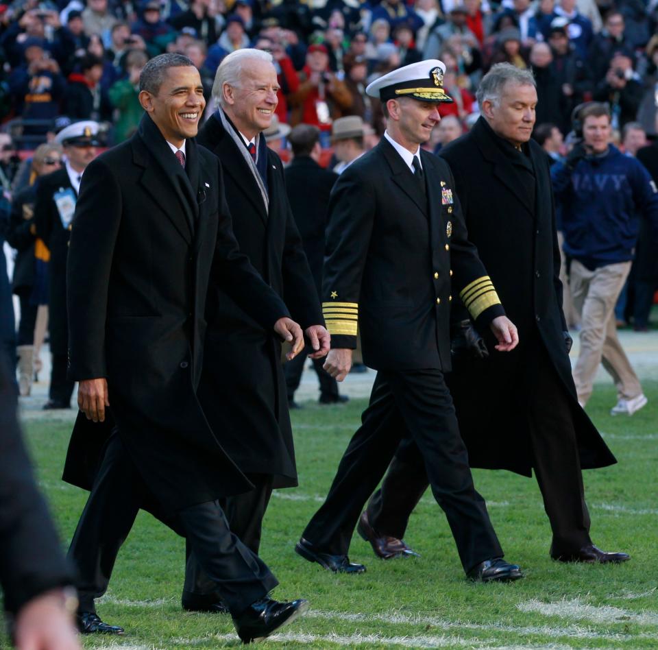 President Barack Obama and Vice President Joe Biden, from left, walk onto the field for the coin toss at the start of the 112th edition of the annual Army vs. Navy football game at FedEx Field in Landover, Md., on Dec. 10, 2011.