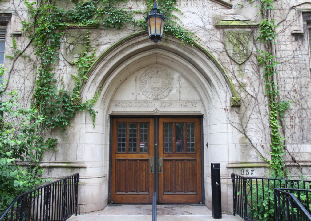 A stone law building covered in Ivy.