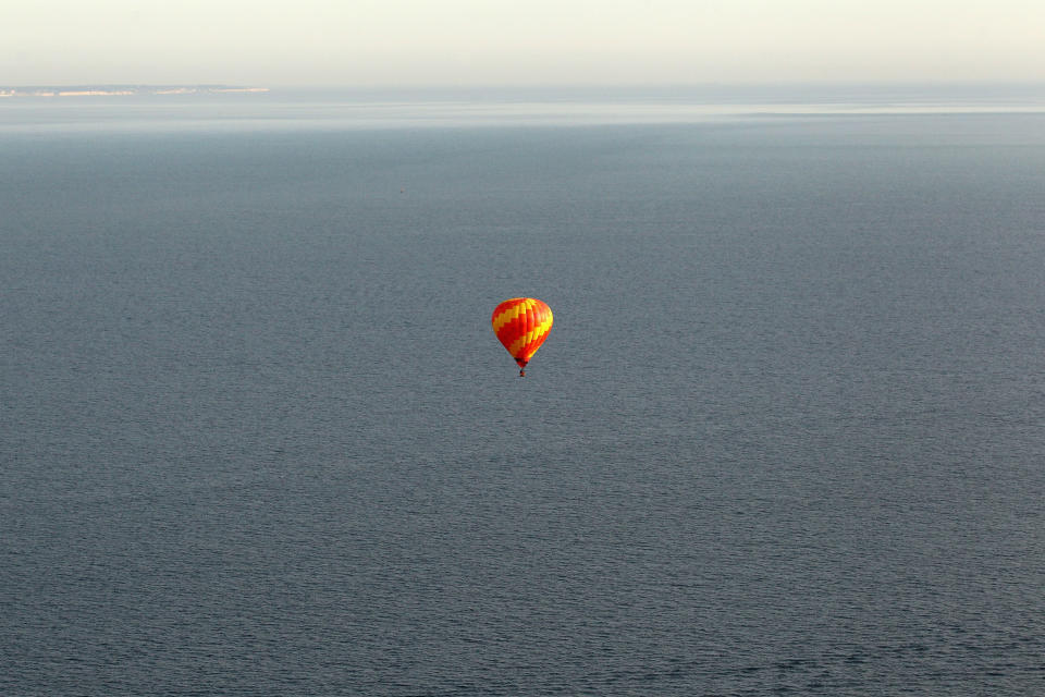 IN FLIGHT - APRIL 07: A hot air balloon which departed from Lydden Hill race circuit near Canterbury takes part in a mass crossing of the Channel on April 7, 2011 in Flight over the English Channel. 51 balloonists of various nationalities from across Europe took off from Kent making for Calais, France at about 7am. It is the first time a Guinness World Record bid has been made for "the largest group of hot air balloons to make the Channel crossing". (Photo by Oli Scarff/Getty Images)