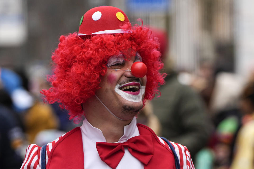 A dressed reveller waits for the traditional carnival parade in Duesseldorf, Germany, on Monday, Feb. 20, 2023. The foolish street spectacles in the carnival centers of Duesseldorf, Mainz and Cologne, watched by hundreds of thousands of people, are the highlights in Germany's carnival season on Rosemonday. (AP Photo/Martin Meissner)