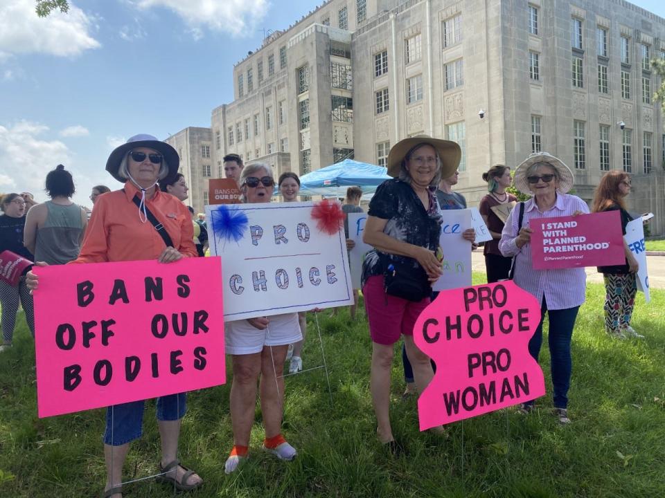 Women hold their pro-choice signs.