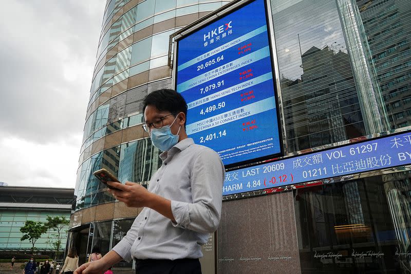 FILE PHOTO: The Hang Seng stock index is displayed on a screen outside Hong Kong Exchanges