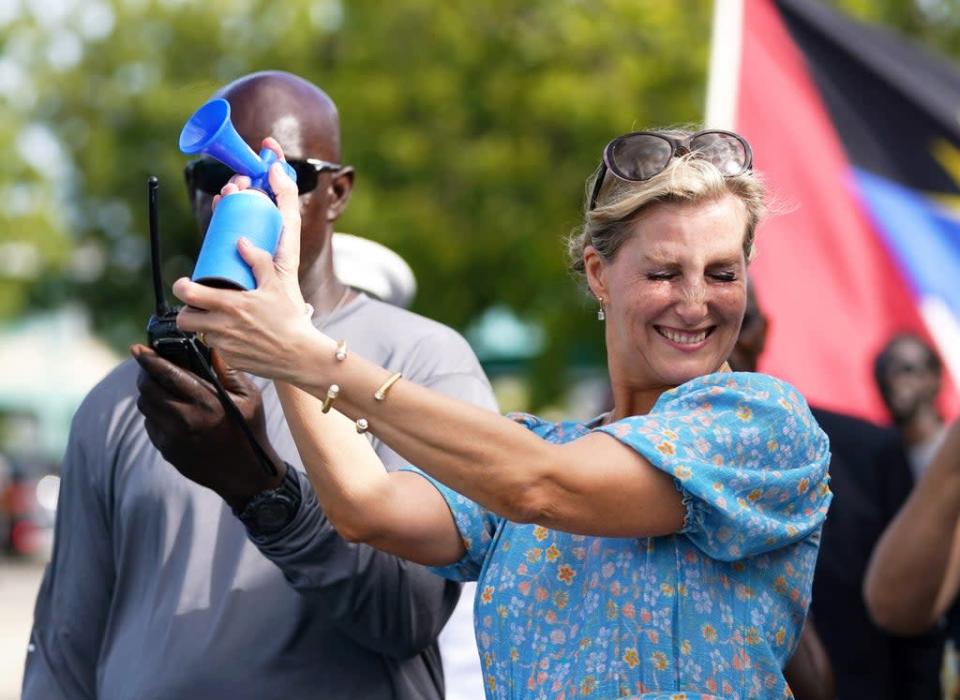 The Countess of Wessex sounds a horn to signal the start of a boat race in Antigua and Barbuda (Joe Giddens/PA) (PA Wire)