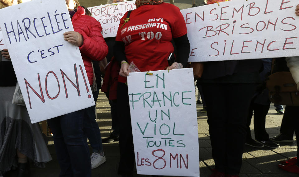 FILE - In this Oct.29, 2017 file photo, demonstrator holds placard reading "Harassed it is no", "In France a rape every 8 minutes" and "Together let us break the silence", during a demonstration in Marseille, southern France. Thousands of French women have denounced in a new online campaign the shocking response of police officers victim-blaming them or mishandling their complaints as they were reporting sexual abuse. (AP Photo/Claude Paris, File)