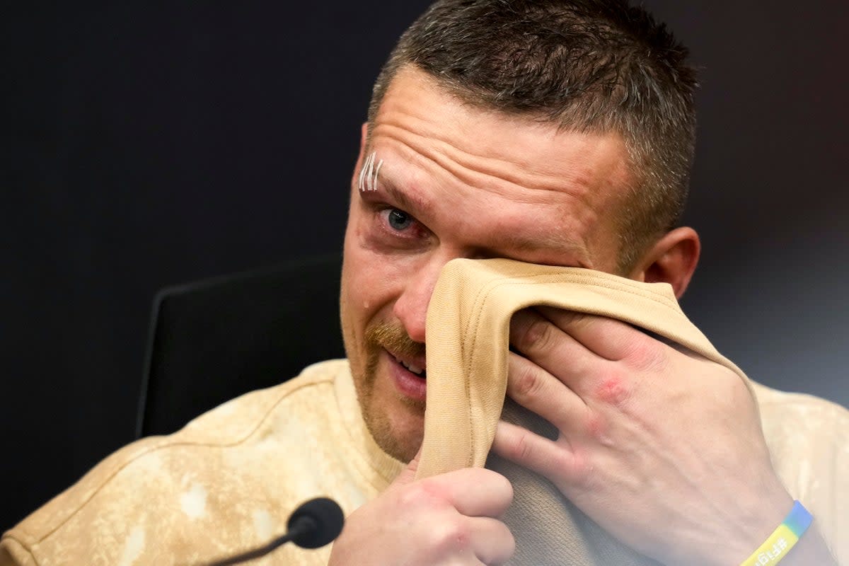 Emotional: Oleksandr Usyk wiped away tears as he discussed his late father after beating Tyson Fury (AP)