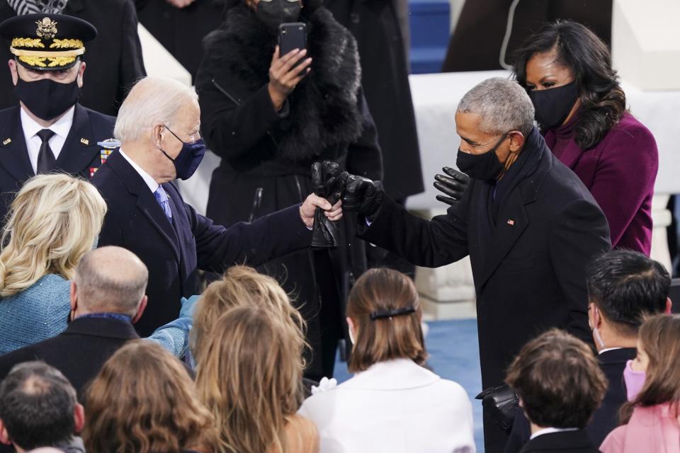 <p>Joe Biden gets a fist bump from friend Barack Obama ahead of his swearing in. </p>