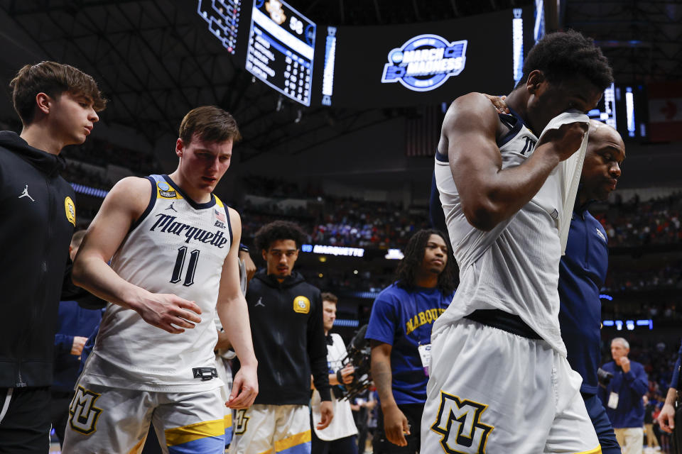 Marquette's Kam Jones, right, Tyler Kolek (11) and teammates walk off the court after their team lost 67-58 to North Carolina State in a Sweet 16 college basketball game in the NCAA Tournament in Dallas, Friday, March 29, 2024. (AP Photo/Brandon Wade)