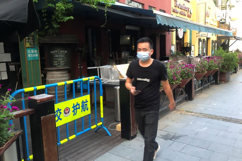 Man walks by McCawley's bar in the Shekou area of Shenzhen