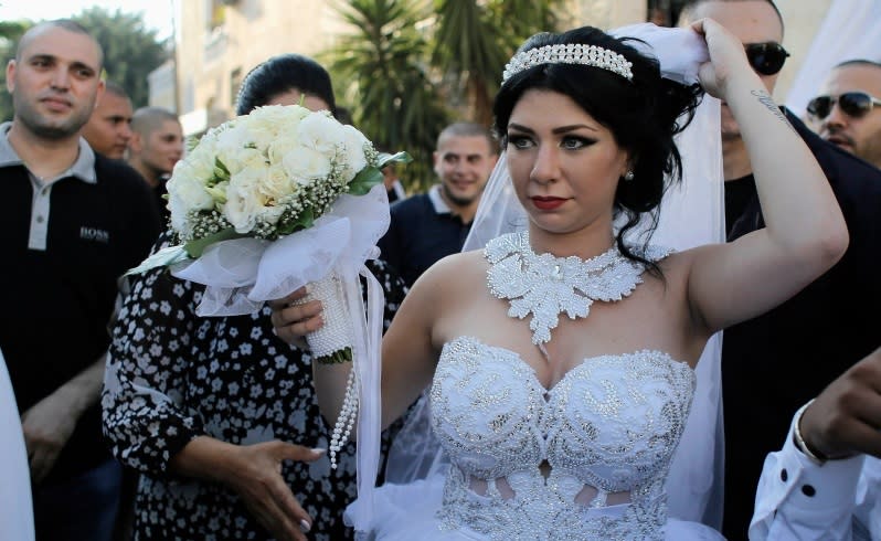 Bride Maral Malka, 23, celebrates with friends and family before her wedding to groom Mahmoud Mansour, 26, (not pictured) in Jaffa, south of Tel Aviv August 17, 2014. Israeli police on Sunday blocked more than 200 far-right Israeli protesters from rushing guests at the wedding of a Jewish woman and Muslim man as they shouted "death to the Arabs" in a sign of tensions stoked by the Gaza war. Picture taken August 17, 2014. To match MIDEAST-ISRAEL/WEDDING REUTERS/Ammar Awad