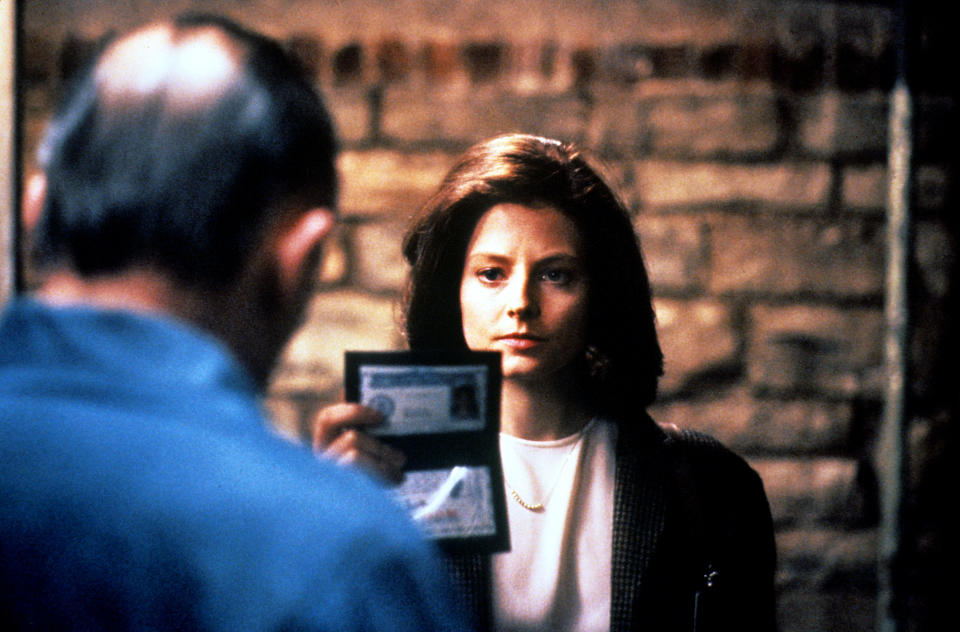 Jodie holding up her FBI badge in a scene from "The Silence of the Lambs"