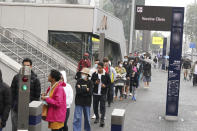 People queue at an NHS Vaccination Clinic at Tottenham Hotspur's stadium in north London, Sunday, June 20, 2021. The NHS is braced for high demand as anyone in England over the age of 18 can now book a Covid-19 vaccination jab. (Yui Mok/PA via AP)