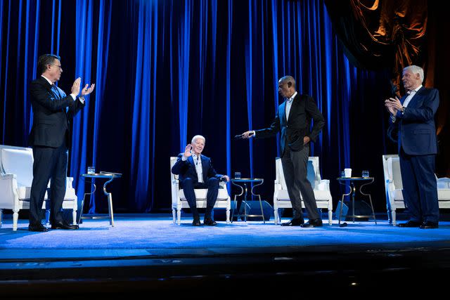 <p>BRENDAN SMIALOWSKI/AFP via Getty</p> Host Stephen Colbert (left) with President Joe Biden and former Presidents Barack Obama and Bill Clinton