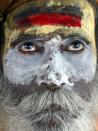 A Sadhu, or Hindu Holy man, looks on after applying sandalwood and vermilion paste on his face in Allahabad, India, Friday, Aug. 25, 2006. Allahabad, on the confluence of the rivers Ganges, Yamuna and the mythical Saraswathi, is one of Hinduism's important centers. (AP Photo/Rajesh Kumar Singh)