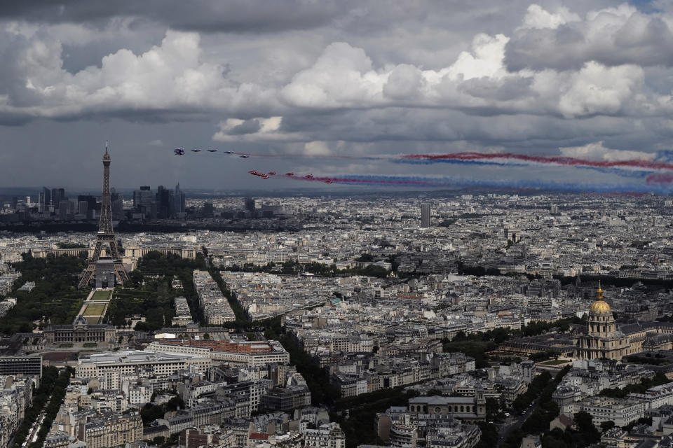 French Alpha jets of the Patrouille de France and the UK Royal red arrows aerobatic planes spraying lines of smoke in the colors of the French flag fly over the Eiffel Tower in Paris, Thursday, June 18, 2020 as part of commemoration for the 80th anniversary of Charles de Gaulle's radio appeal to his countrymen to resist Nazi occupation during WWII. French President Emmanuel Macron is traveling to London to mark the day that De Gaulle delivered his defiant broadcast 80 years ago urging his nation to fight on despite the fall of France. In a reflection of the importance of the event, the trip marks Macron's first international trip since France's lockdown amid the COVID-19 pandemic. (AP Photo/Francois Mori)