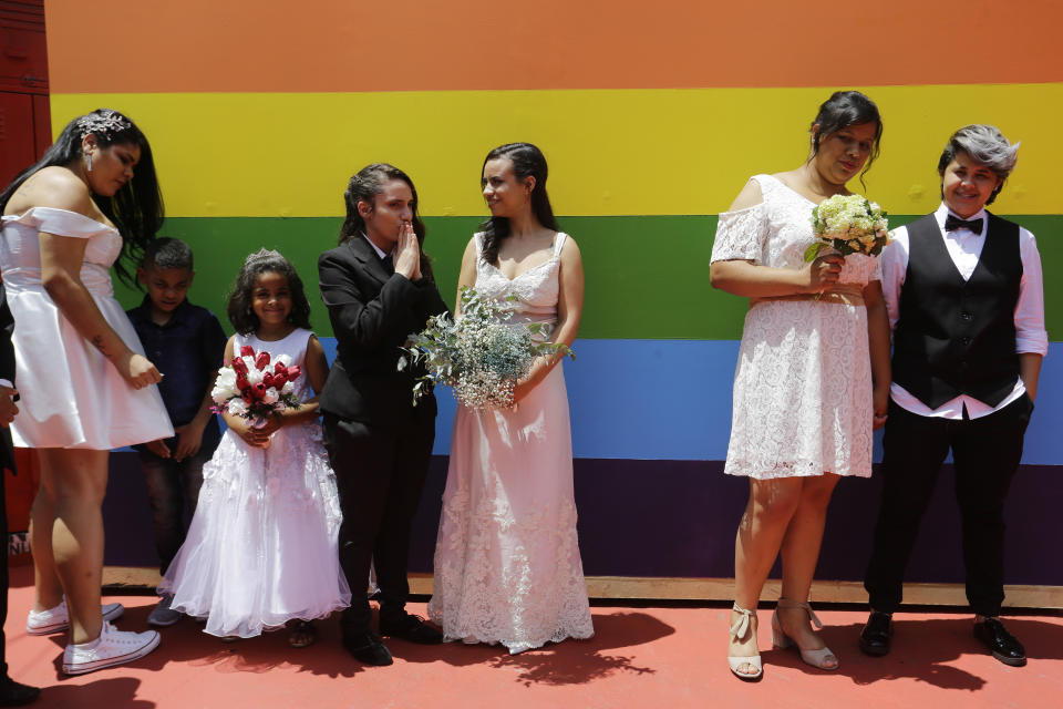 FILE - In this Dec. 15, 2018 file photo, same sex couples wait to get married prior to a group marriage of forty same sex couples in Sao Paulo, Brazil. Brazil’s supreme court has officially made homophobia and transphobia crimes similar to racism, with the final justices casting their votes on Thursday, June 13, 2019 in a ruling that comes amid fears the country far-right administration seeks to roll back LGBT social gains. (AP Photo/Nelson Antoine, File)