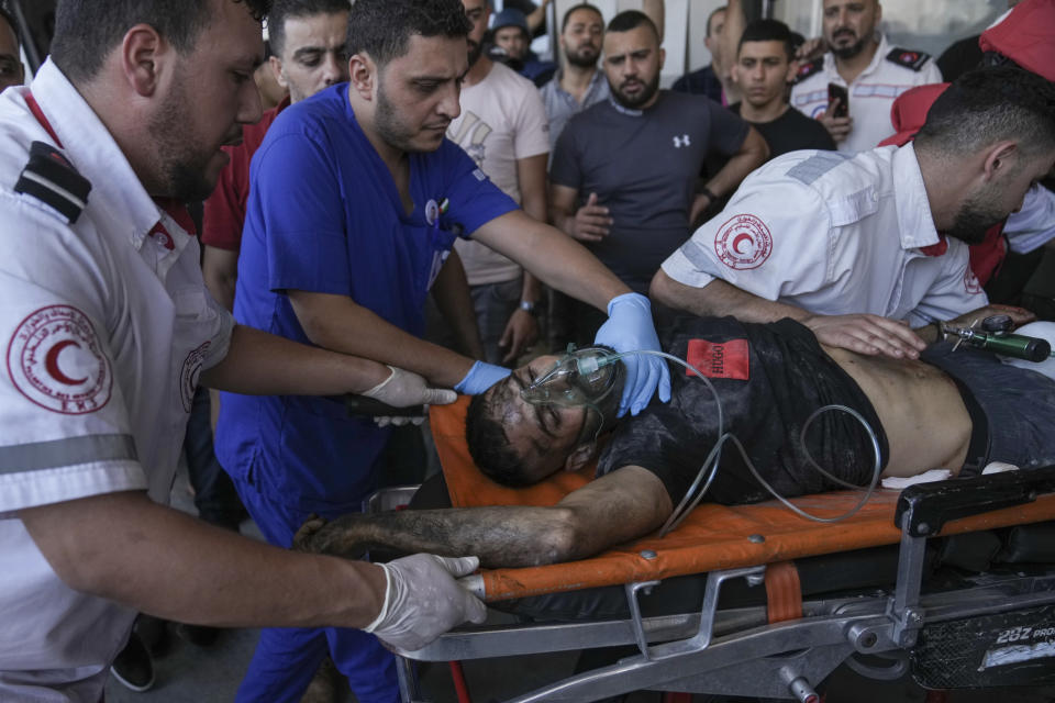 An injured Palestinian is carried into a hospital during an Israeli military raid in the Jenin refugee camp, a militant stronghold in the occupied West Bank, Monday, July 3, 2023. Israeli drones struck targets in the area early Monday and hundreds of troops were deployed. Palestinian health officials said at least eight Palestinians were killed. (AP Photo/Nasser Nasser)